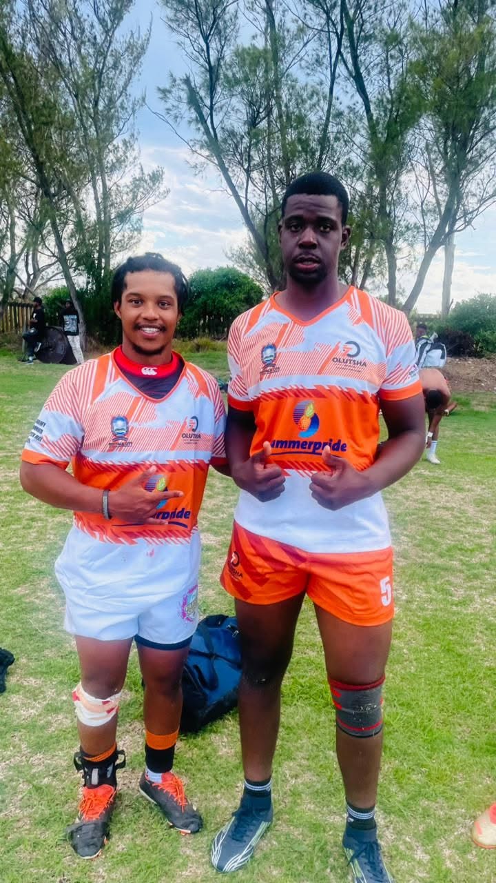 Two Olutsha Wolves team-mates giving thumbs up in the 2026 kit